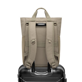 Rückansicht der Wickeltasche 'Blair' in Beige auf einem schwarzen Trolley-Koffer befestigt